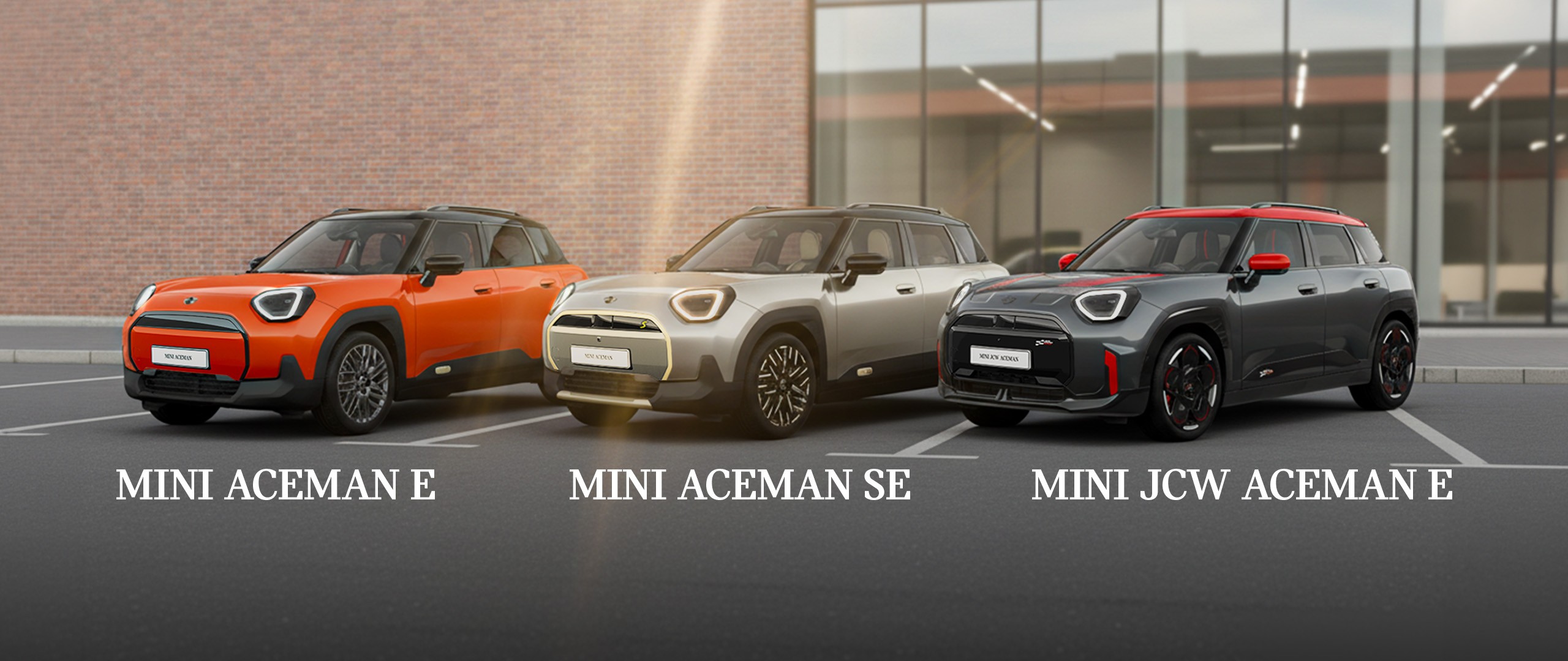 Gray MINI Aceman parked on a city street beside a bright purple and red building, featuring modern design and black roof.